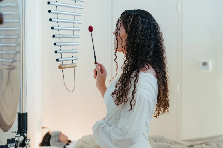 Luisa playing chimes over a guest on the waterbed